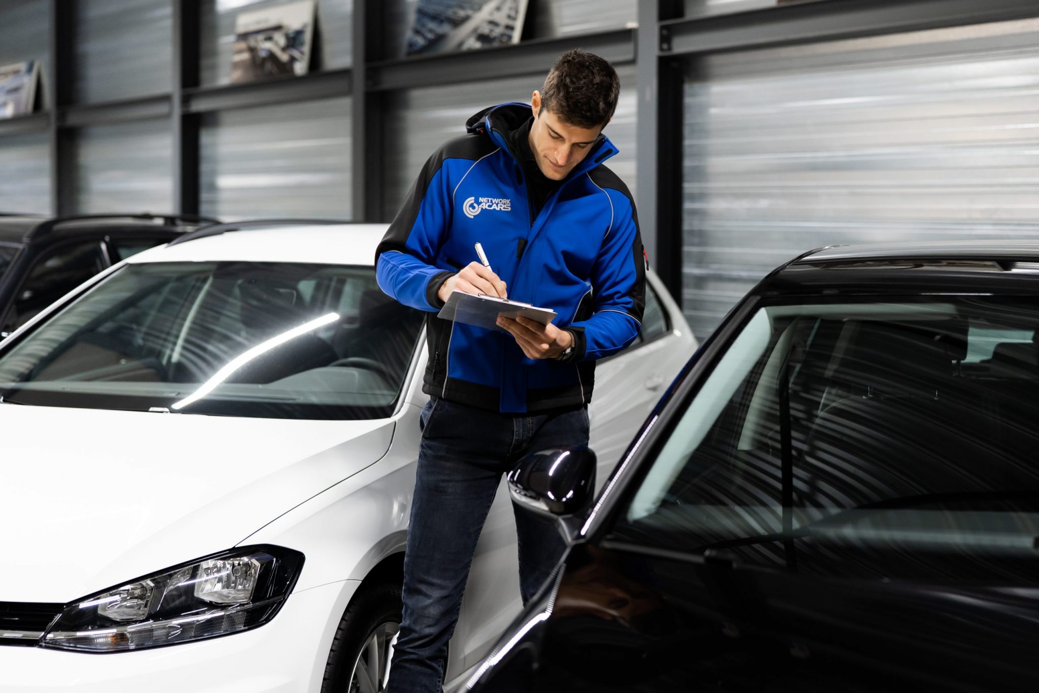 Network4Cars employee standing next to car